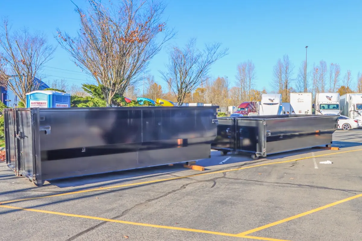 Professional dumpster rental service with roll-off container on residential driveway in East Norriton